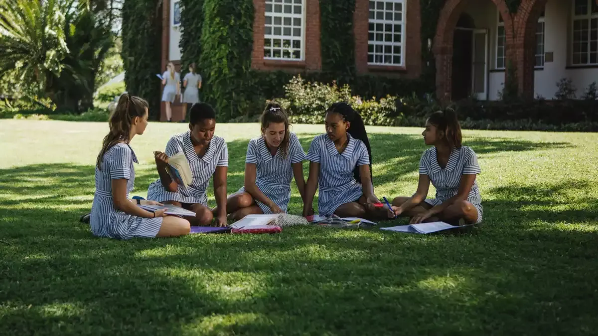 St Mary's girls under a tree on campus